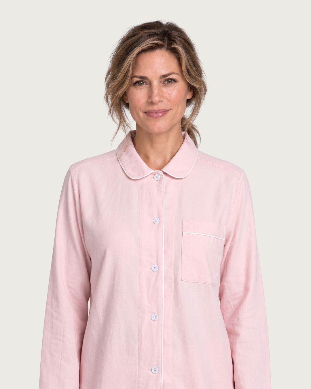 Close-up of Amber pink cotton pajama top with rounded collar, buttons and chest pocket
