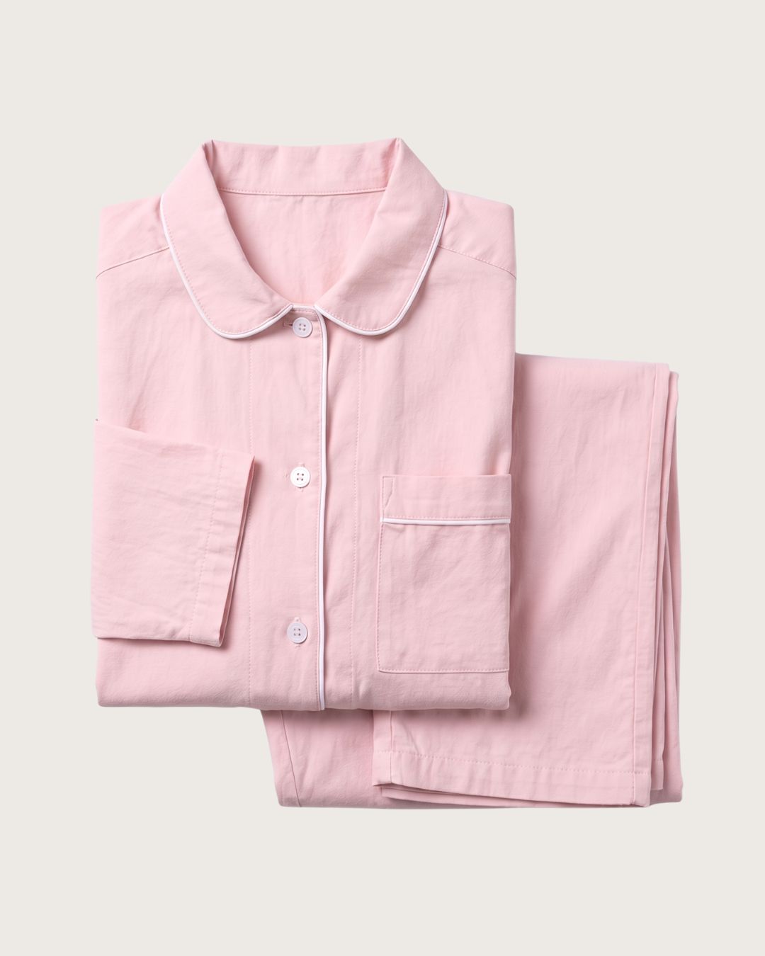 Folded Amber pink cotton pajama set with button-front top and matching pants