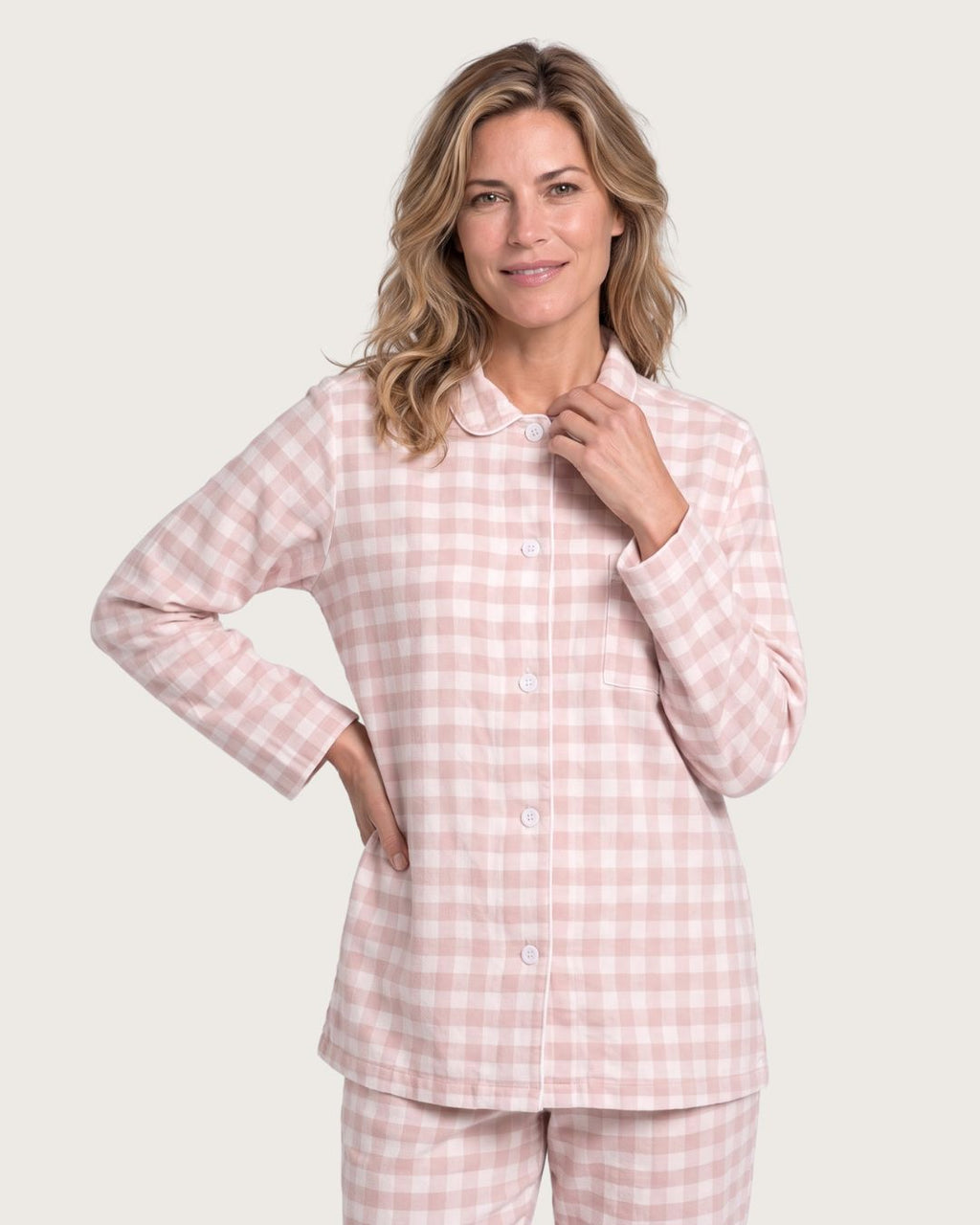 Woman wearing the Faye pink plaid flannel pajama top, upper-body studio view