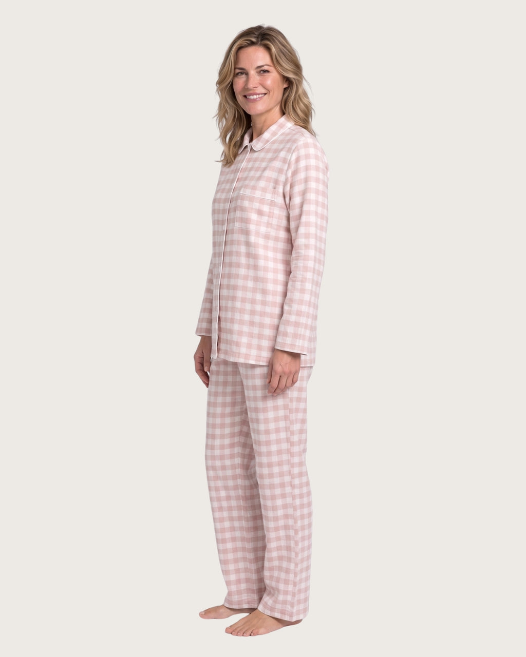 Woman wearing the Faye pink plaid pajama set, full-body side view