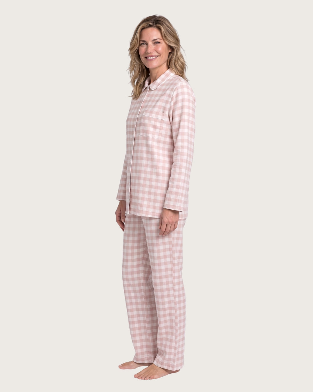Woman wearing the Faye pink plaid pajama set, full-body side view