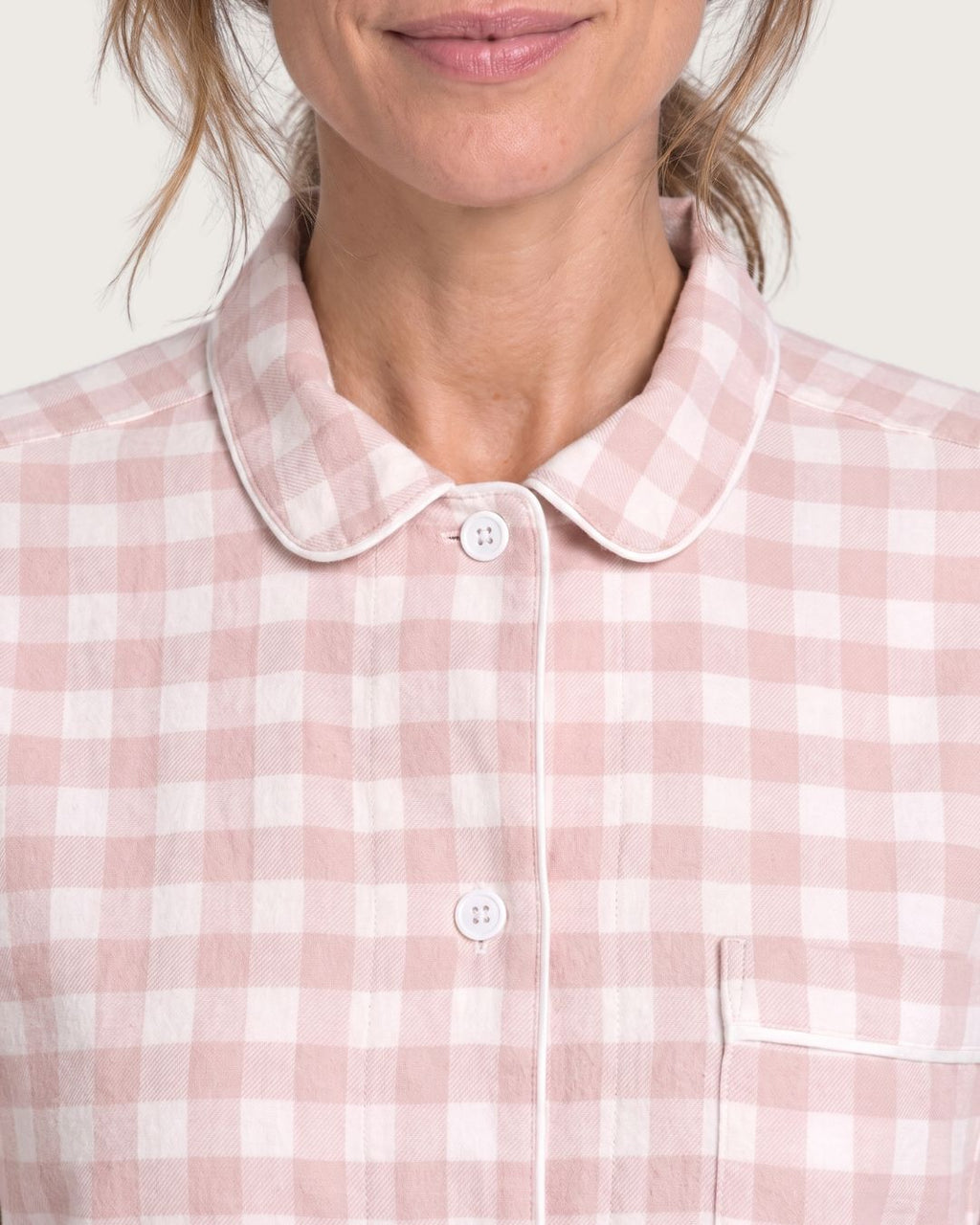 Close-up of Faye pink plaid pajama top with rounded collar and chest pocket