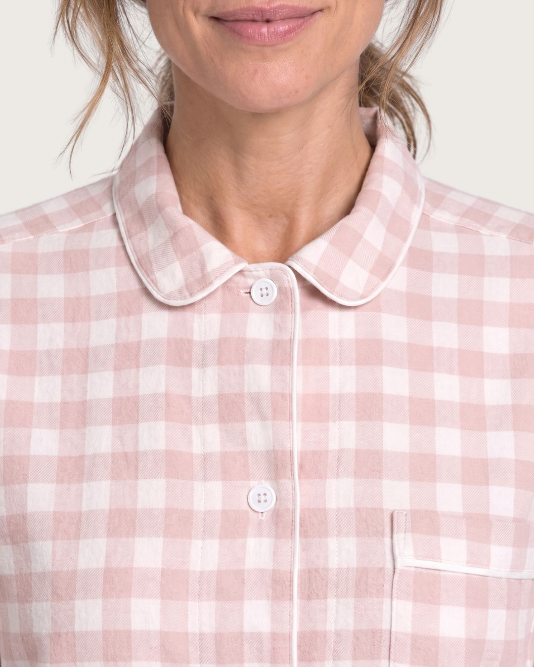 Close-up of Faye pink plaid pajama top with rounded collar and chest pocket