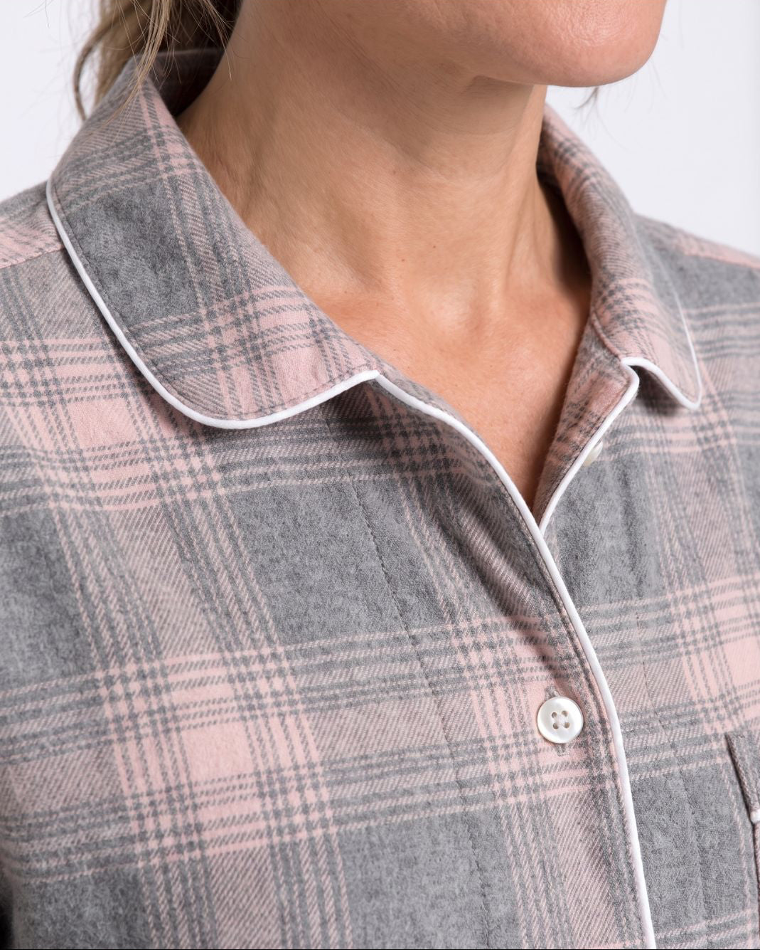 Close-up of Laurel pajama top chest pocket, buttons and plaid fabric detail