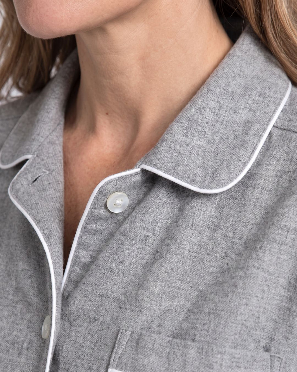 Close-up of gray cotton pajama collar with contrast white piping and button